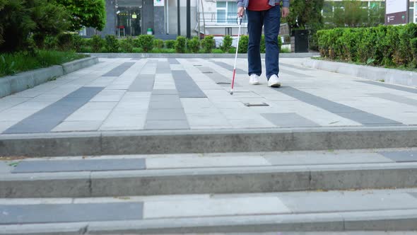 Young Blind Man with Using Safety Stick for Walking Alone Outdoors