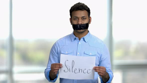 Silence Concept Young Indian Man with Taped Mouth