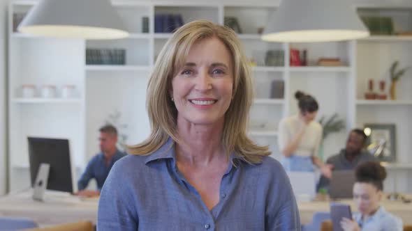 Woman smiling to camera at the office