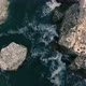 Aerial view of a couple at the rocky seashore - VideoHive Item for Sale