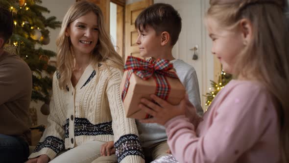 Family sharing the Christmas presents at home. Shot with RED helium camera in 8K