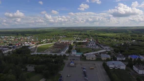 Aerial view monastery surrounded by a brick wall on the edge of the city 21