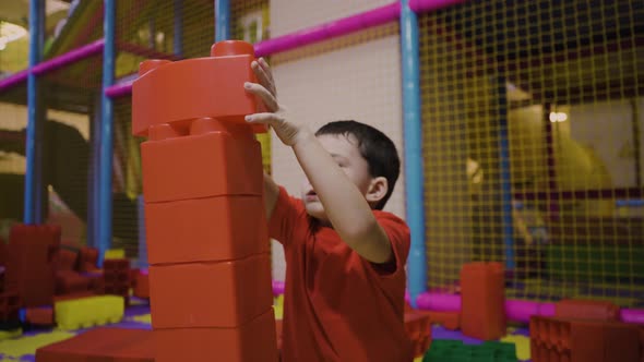 A Fiveyearold Boy Builds a Tower From a Large Construction Set
