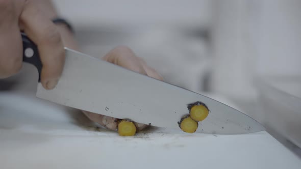 Chef Slices Vegetables on Restaurant Kitchen Counter Slomo Closeup