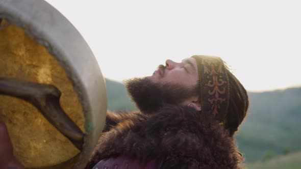 Bearded Man Plays Shamanic Drum Dancing in Ecstasy