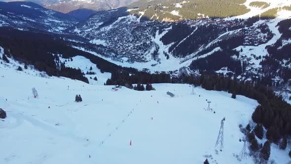 Aerial View of the Alps Mountains in France. Mountain Tops Covered in Snow. Alpine Ski Facilities