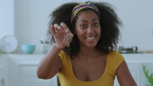 Blurred Happy Woman Smiles Cheerful Toothy Smile Showing Keychain with Apartment Keys in New House