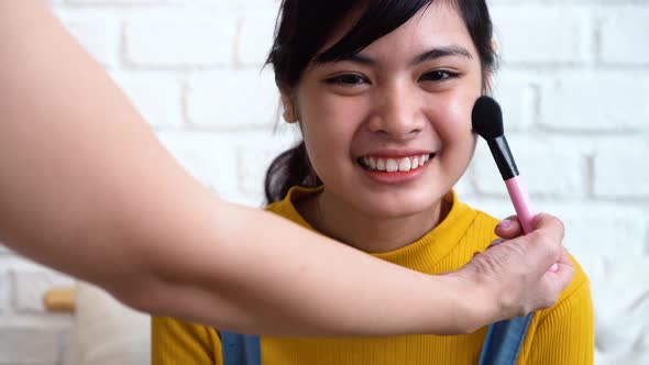 Makeup Artist Applying Makeup for Young Asian Teenage Girl