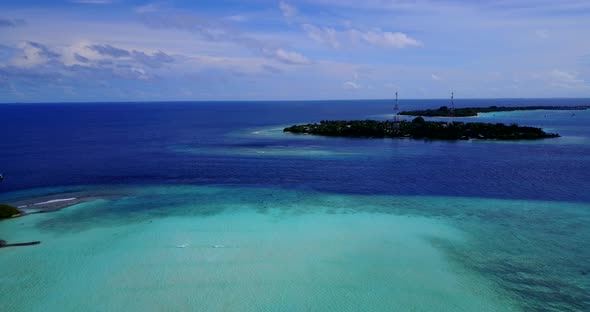 Luxury flying abstract view of a white paradise beach and blue water background in best quality 4K