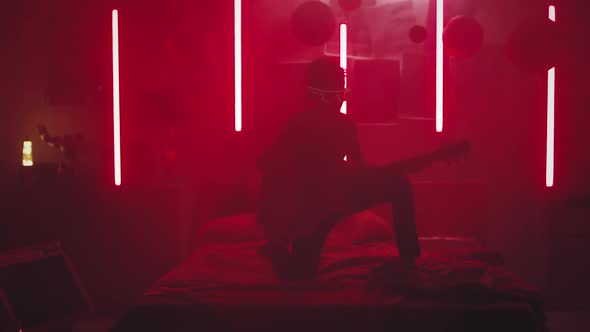 Teen Rocker Playing Guitar in Smoke