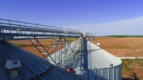 Aerial view. Metal grain elevator in agricultural zone. Grain warehouse