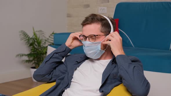 Man Listening To Music on Headphones While Is Sitting on a Bean Bag