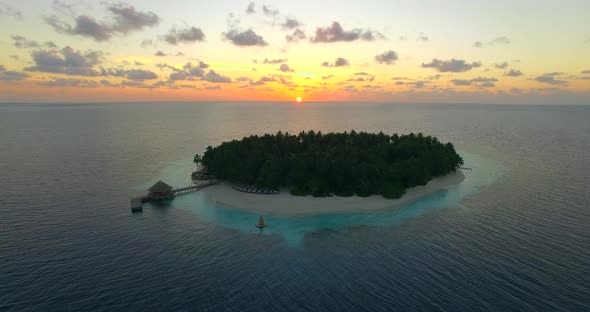 Aerial drone view of scenic tropical islands at sunset in the Maldives.