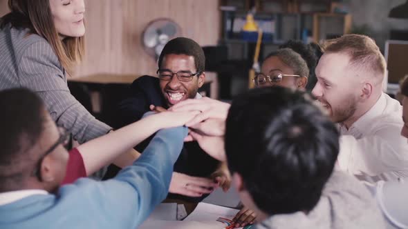 Happy Successful Multiethnic Business People Joining Hands, Encouraged By Caucasian Female Team