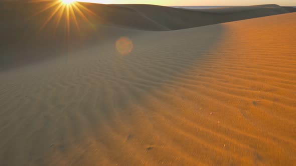 Maspalomas Desert, Gran Canaria. Сamera Moves Along the Sand in the Rays of Rising Sun. Steadicam, 