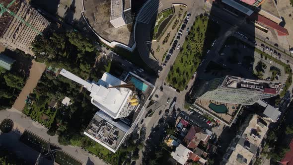 Top View of the Streets of Batumi with Lots of Traffic Near a Huge Skyscraper