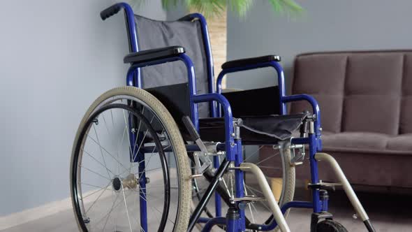 Wheelchair in a Bright Room Near the Sofa