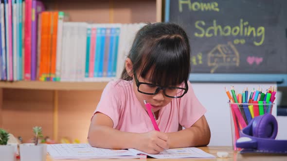 Asian female students studying at home during quarantine. New Normal. Home schooling. alt