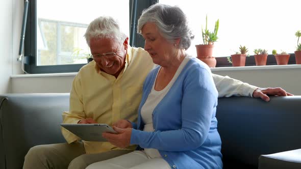 Senior couple using digital tablet