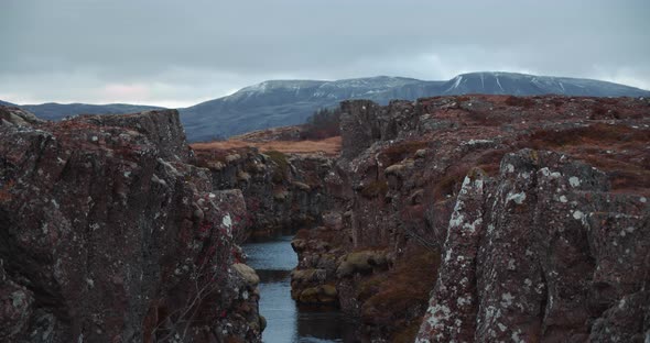 River Through Rugged Canyon With Mountains