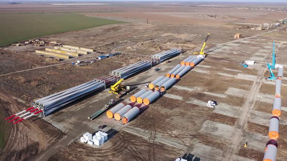 Massive Cranes Are Parked Near the Huge Parts of Wind Turbines, 