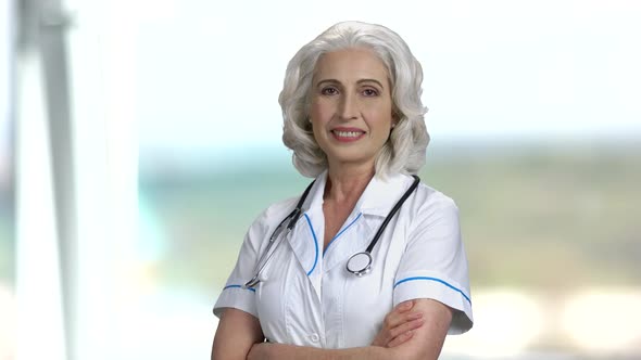 Smiling Doctor Looking at Camera with Arms Crossed.