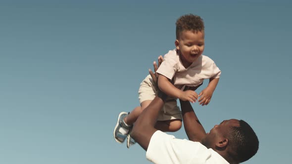 Man with Toddler Son at Beach