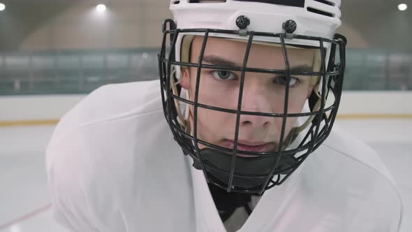 Portrait Of Male Hockey Player In Helmet With Cage