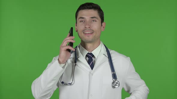 Young Doctor Using Talking on Cellphone, Chroma Key