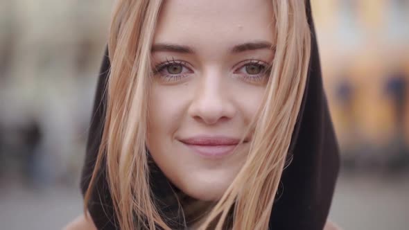 Closeup Portrait of Female Lovely Face with Green Eyes and Clean Skin Smiling Joyfully While Wind