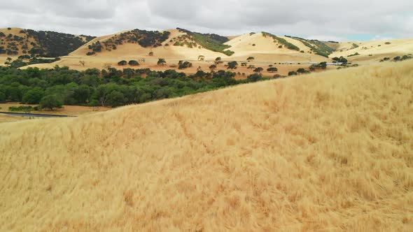 Aerial of Highway in Dry Grass Hill Landscape