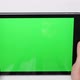 Close Up of Hands Holding a Tablet PC with Green Mockup Screen - VideoHive Item for Sale