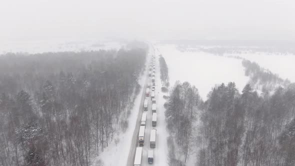 Trucks are Stuck in Traffic on a Snowcovered Highway