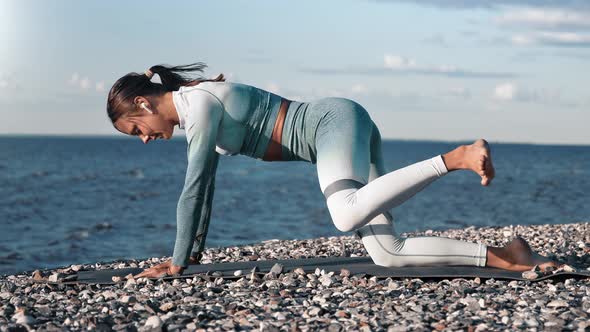 Muscular Sport Lady Training on Beach Exercising with Fitness Rubber Enjoying Physical Activity