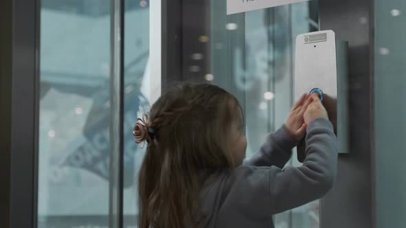 Little Girl Presses the Elevator Call Button