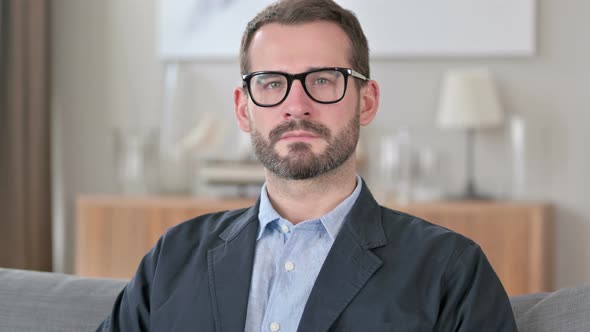 Portrait of Attractive Young Businessman Looking at Camera 