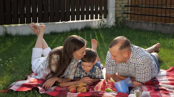 Happy Family Lies Speaks and Laughs on Bright Blanket