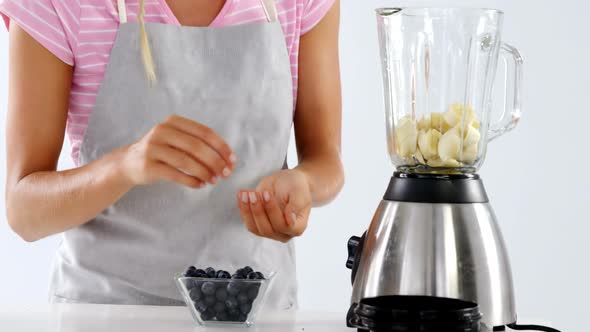 Woman preparing smoothie