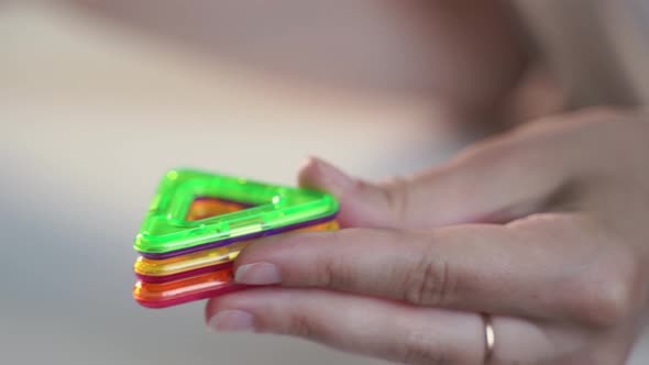 Close Up of Magnetic Building Toy. WOman Playing with Preschooler. 