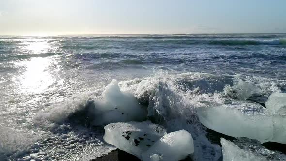 Ice From a Glacier Washing By Atlantic Ocean Waves on a Black Diamond Beach in Iceland. Global