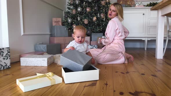 Mother's Christmas Mood with Her Child, Near the New Year Tree. Winter Holidays