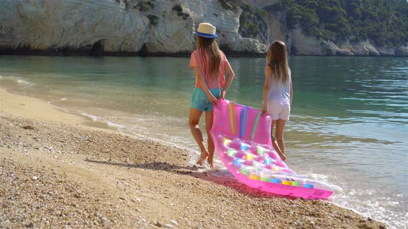 Little Girls Having Fun at Tropical Beach During Summer Vacation Playing Together