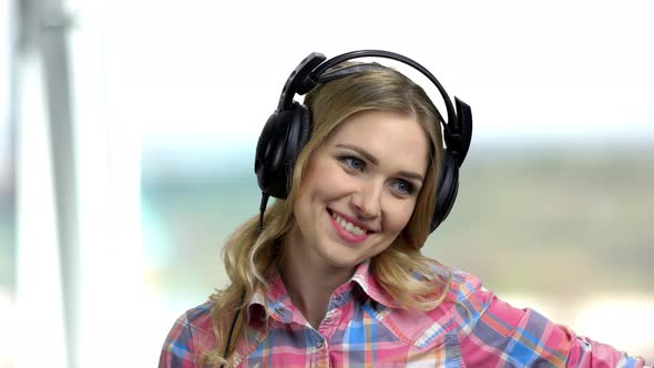 Close Up Young Happy Woman Using Headphones.