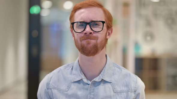 Portrait of Sad Casual Redhead Man Crying at Camera 