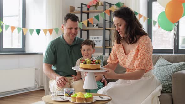 Happy Family with Birthday Cake at Home Party