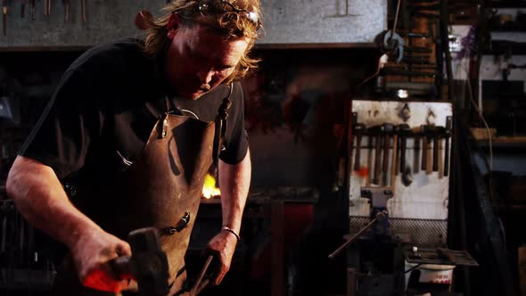 Blacksmith working on a iron rod