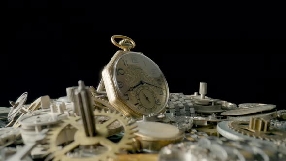 Gold Vintage Pocket Watch Dial on Pile of Clockwork Parts