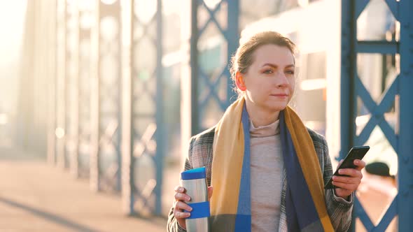 Portrait of a Young Caucasian Businesswoman in a Coat Walking Around the City on a Frosty Morning