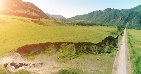 Aerial Rural Mountain Road and Meadow at Sunny Summer Morning