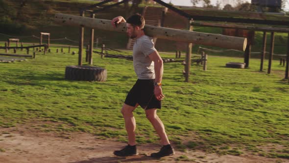 Young man training at an outdoor gym bootcamp